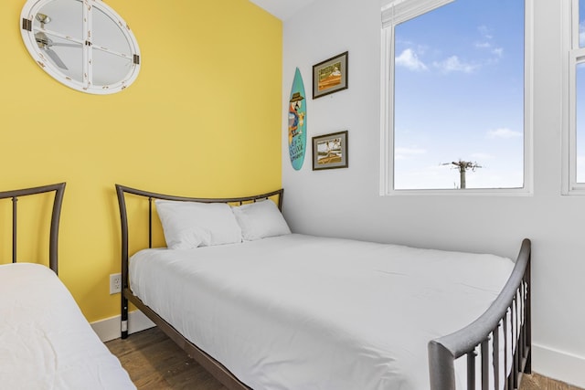 bedroom featuring baseboards and wood finished floors