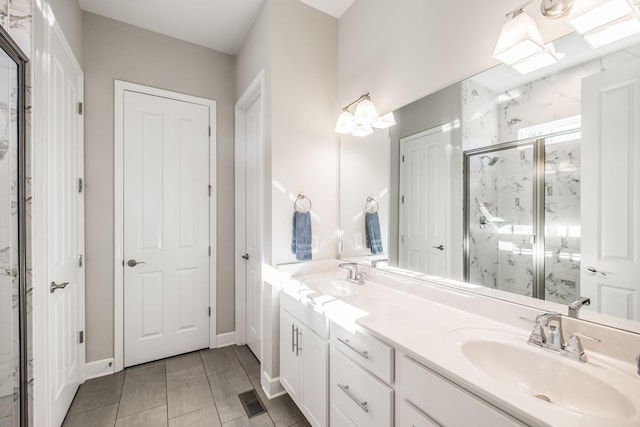 bathroom featuring double vanity, a marble finish shower, visible vents, and a sink