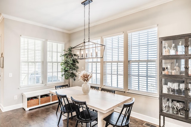 dining space with baseboards, a notable chandelier, dark wood finished floors, and crown molding