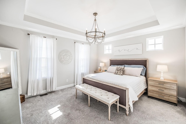 bedroom featuring carpet, a raised ceiling, and a notable chandelier