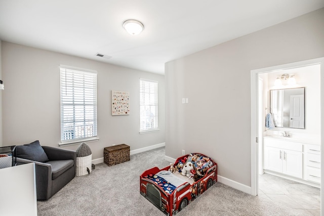 sitting room with baseboards, visible vents, and light colored carpet