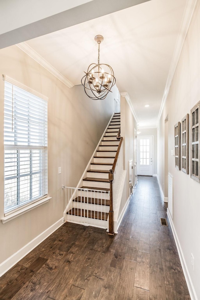 stairs featuring baseboards, ornamental molding, and wood finished floors