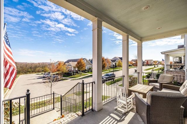 balcony with covered porch and a residential view