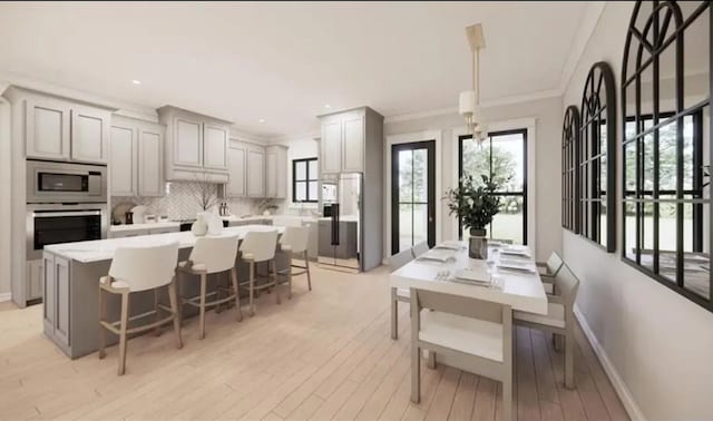 kitchen featuring appliances with stainless steel finishes, pendant lighting, light countertops, and gray cabinetry