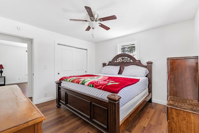 bedroom featuring a closet, baseboards, and dark wood-style flooring