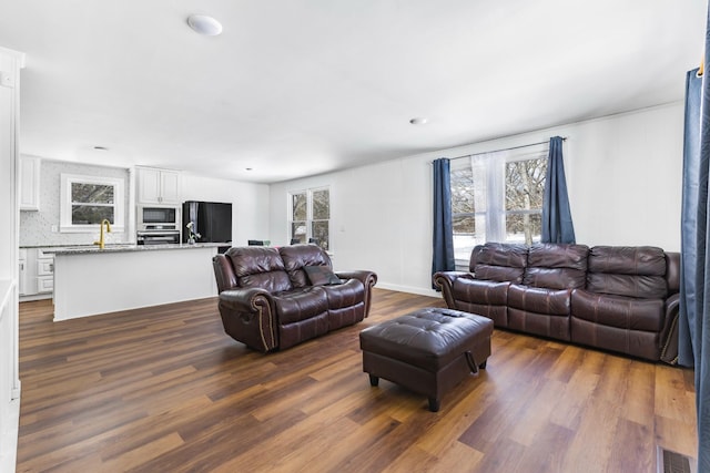 living room with dark wood-type flooring and visible vents