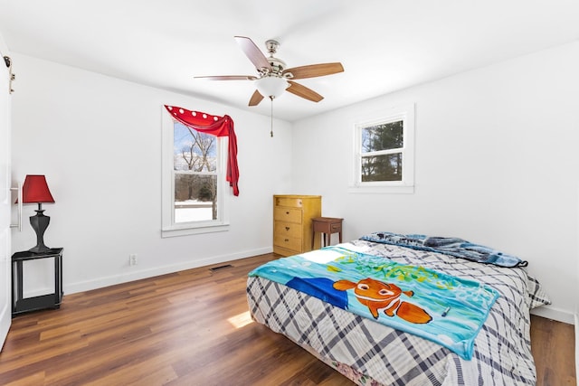 bedroom featuring dark wood-type flooring, visible vents, and baseboards