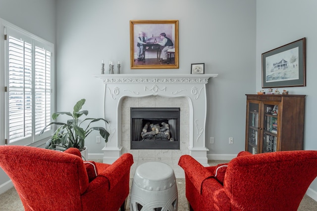 living room featuring a healthy amount of sunlight, a fireplace, and baseboards