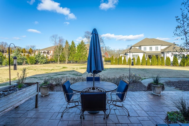 view of patio with a residential view and outdoor dining area