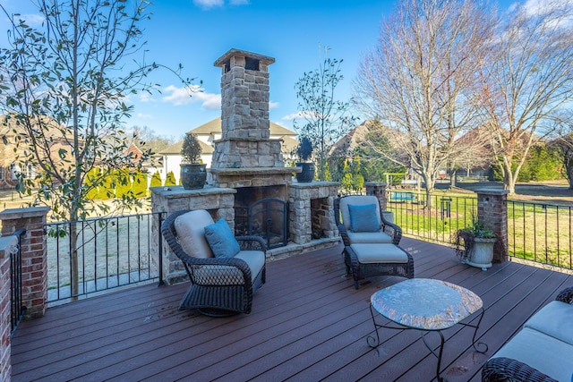 deck with an outdoor stone fireplace