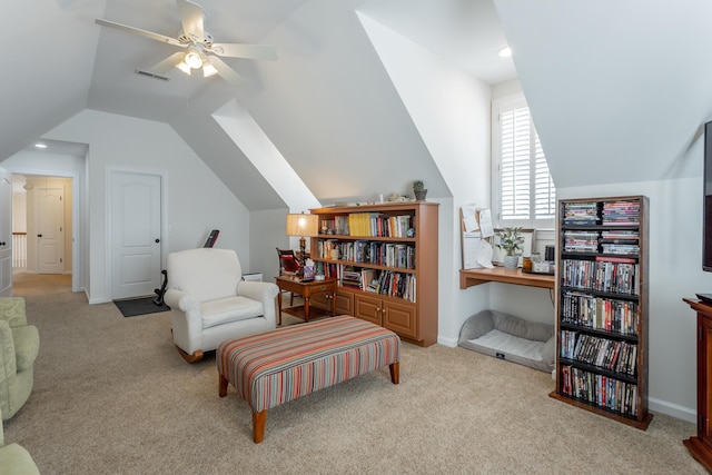 sitting room with lofted ceiling, light carpet, visible vents, and baseboards