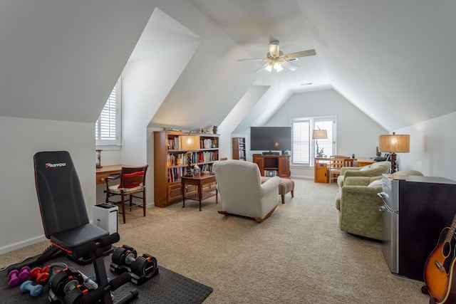 interior space with carpet floors, lofted ceiling, ceiling fan, and baseboards