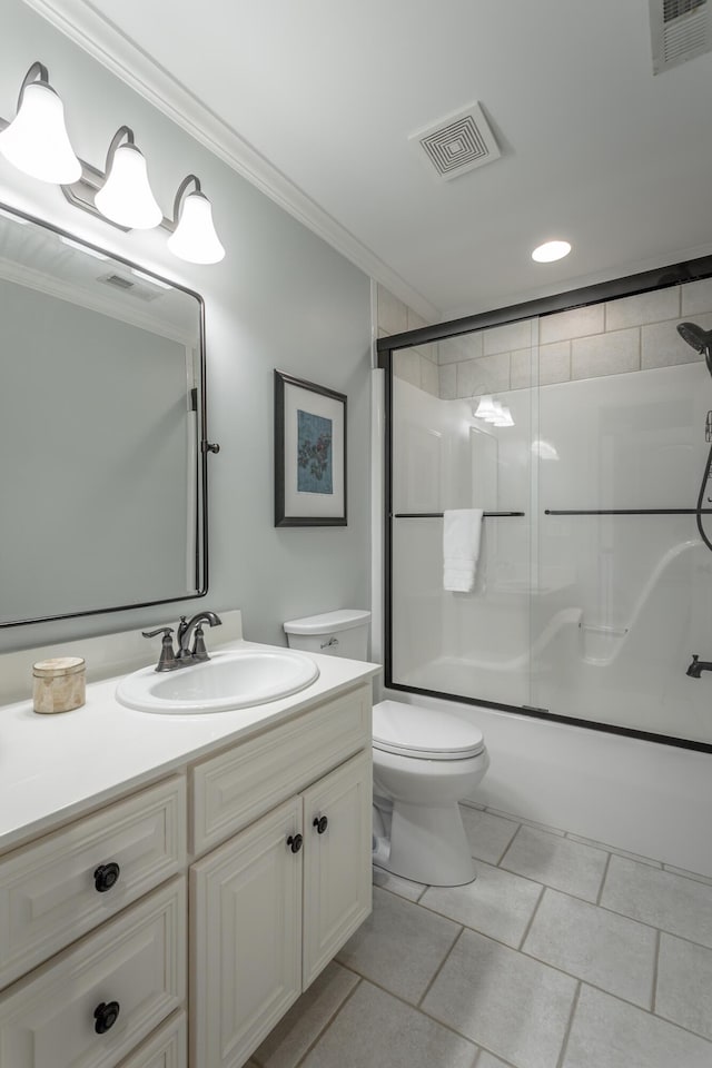 bathroom featuring toilet, combined bath / shower with glass door, visible vents, and crown molding