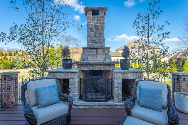 deck featuring an outdoor stone fireplace