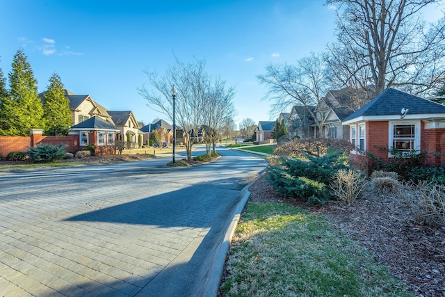 view of street with a residential view and curbs