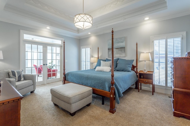 bedroom featuring light carpet, multiple windows, a tray ceiling, and french doors