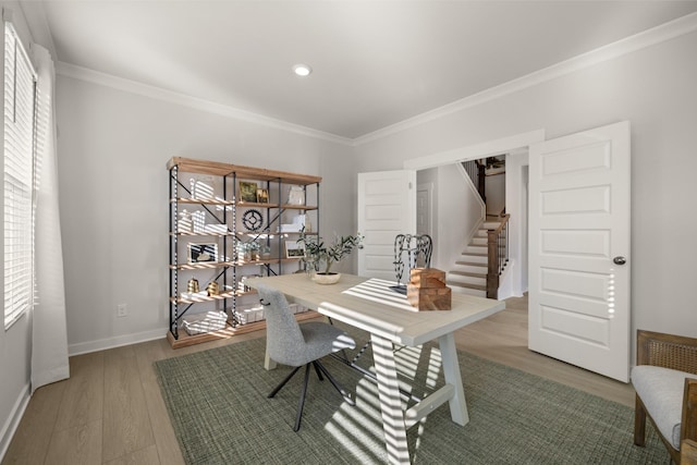 office space with ornamental molding, baseboards, and wood finished floors