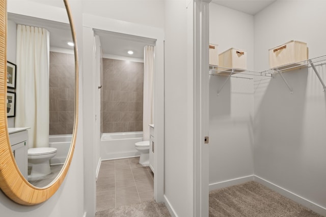 full bath with shower / washtub combination, a walk in closet, vanity, and toilet