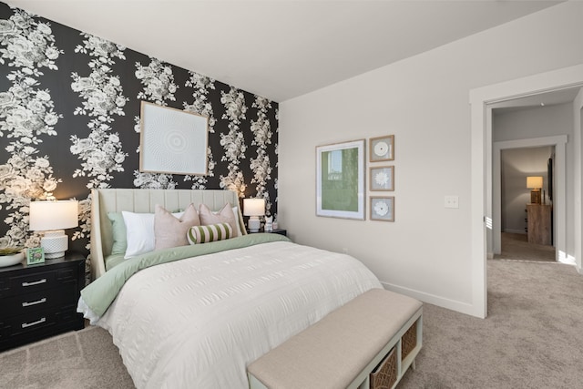 bedroom featuring light carpet, baseboards, and wallpapered walls