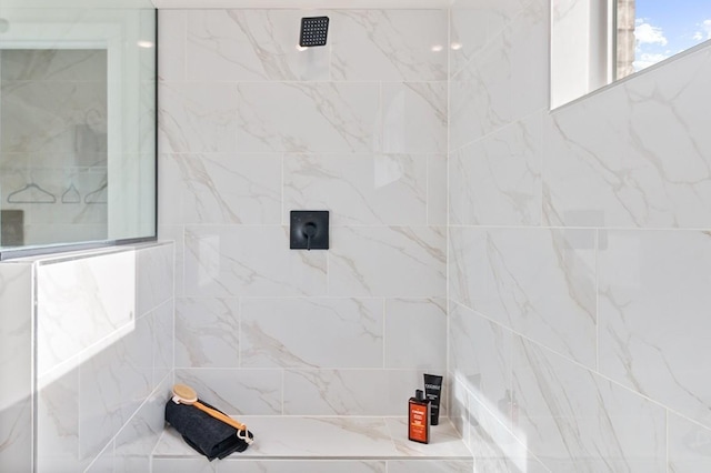 bathroom with tiled shower