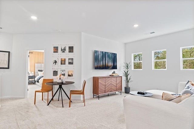 living room with light carpet, visible vents, and recessed lighting