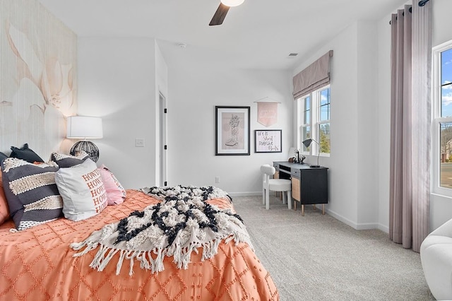 carpeted bedroom featuring baseboards and ceiling fan