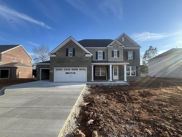 view of front of home featuring driveway, covered porch, an attached garage, and brick siding