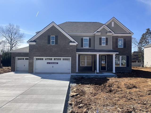 view of front of property with covered porch, driveway, and brick siding