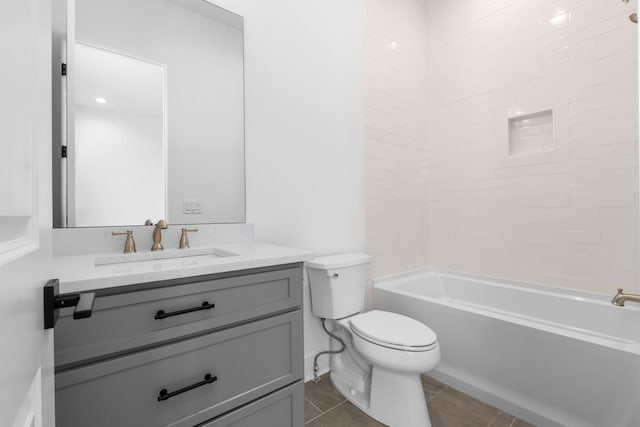 bathroom featuring toilet, tile patterned flooring, washtub / shower combination, and vanity