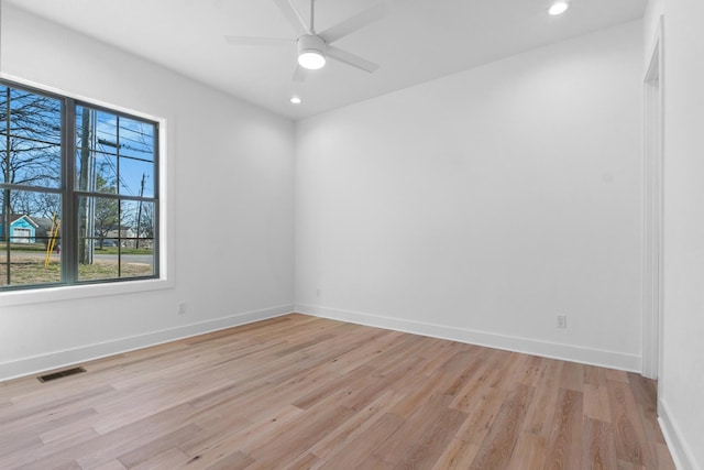 spare room with light wood finished floors, baseboards, visible vents, and recessed lighting