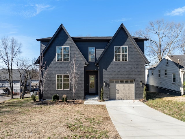 view of front of home with a garage, concrete driveway, and a front yard