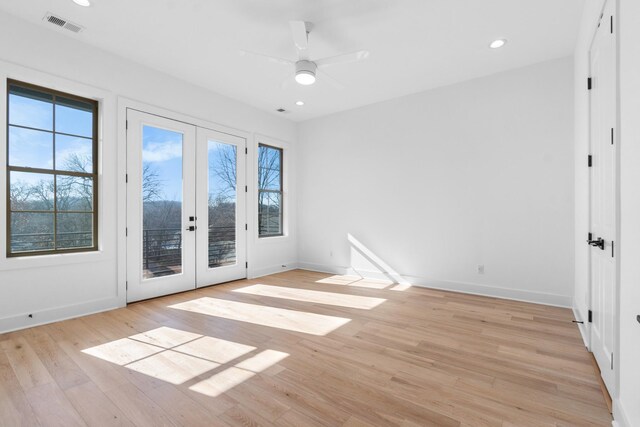 spare room featuring light wood-style flooring, visible vents, a wealth of natural light, and recessed lighting