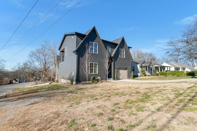 view of front facade with driveway, an attached garage, and a residential view