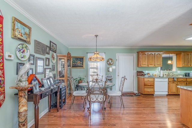 dining space with crown molding, light wood-style flooring, and a textured ceiling