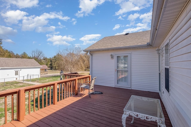 wooden deck with a lawn