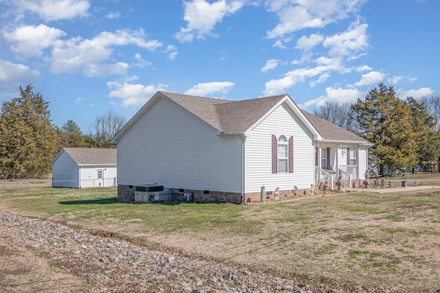 view of side of property featuring roof with shingles, crawl space, cooling unit, and a lawn