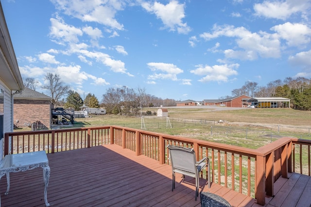 wooden deck featuring a lawn and fence