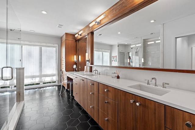 full bath featuring double vanity, visible vents, a sink, and tile patterned floors