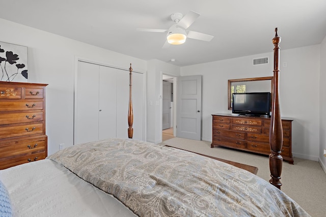 bedroom with light carpet, ceiling fan, visible vents, and a closet