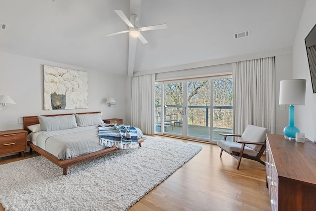 bedroom with light wood finished floors, access to outside, visible vents, and high vaulted ceiling