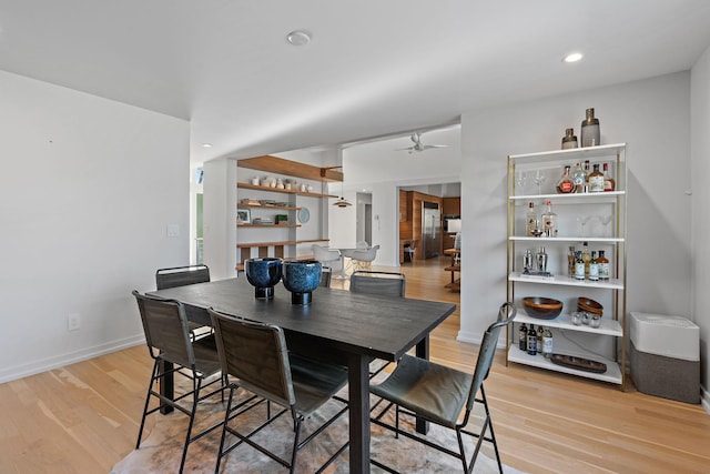 dining area featuring baseboards, recessed lighting, a ceiling fan, and light wood-style floors