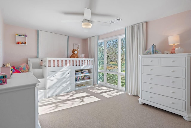 bedroom with ceiling fan, carpet floors, multiple windows, and visible vents