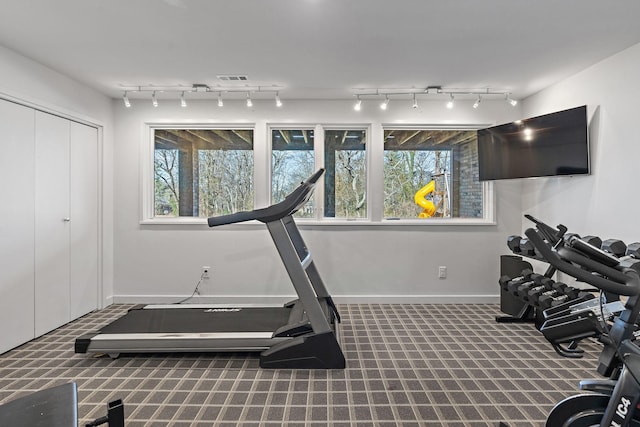 exercise area with track lighting, carpet flooring, visible vents, and baseboards