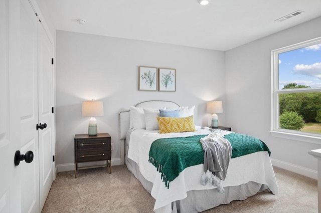 carpeted bedroom featuring visible vents and baseboards