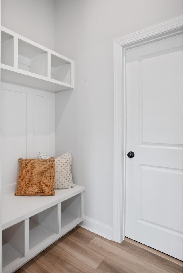 mudroom featuring baseboards and wood finished floors