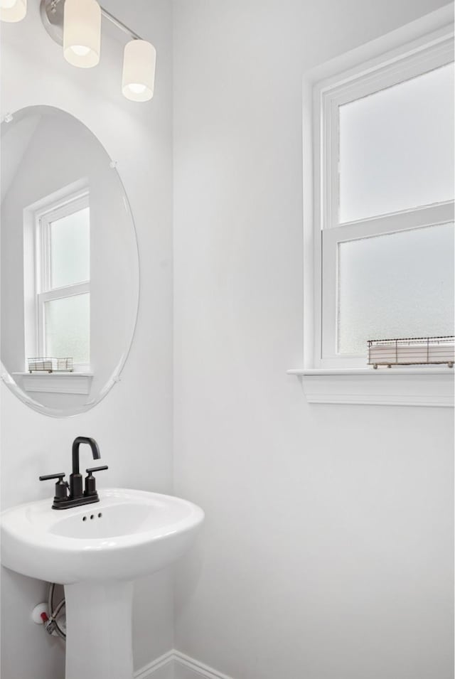 bathroom with baseboards and a sink