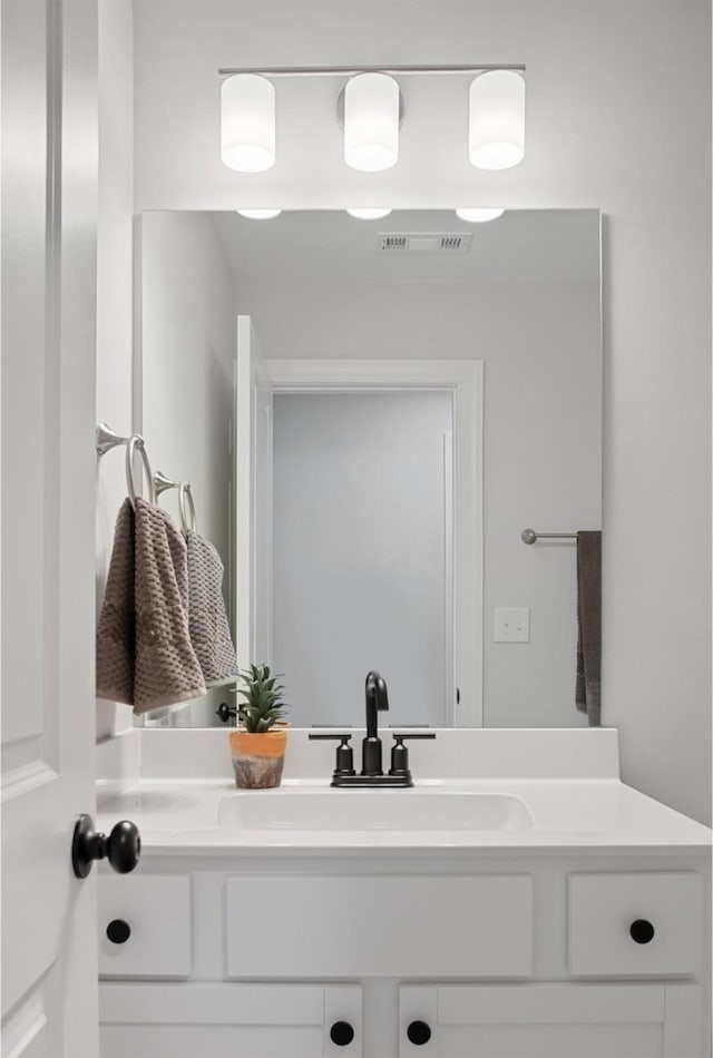 bathroom featuring vanity and visible vents