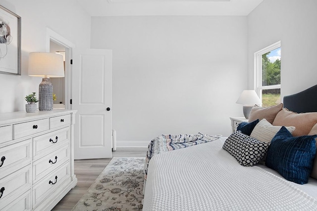 bedroom featuring light wood-style flooring and baseboards