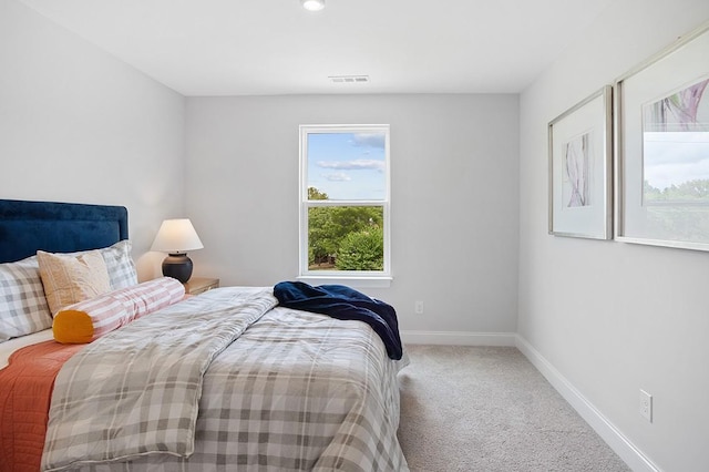 carpeted bedroom with visible vents and baseboards