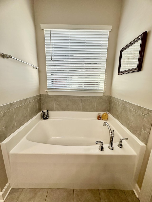 full bath featuring a garden tub and tile patterned floors